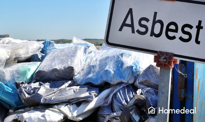 In plastic verpakt asbestafval in een container met aanwijzingsbord.