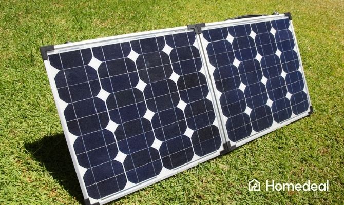 Twee kleine monokristallijne zonnepanelen opgesteld op een grasveld, geschikt voor draagbare of tijdelijke zonne-energie toepassingen.